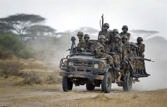 In this Monday, Feb. 20, 2012 file photo, Kenyan army soldiers ride on a vehicle at their base in Tabda, inside Somalia. 