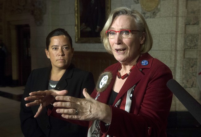 Minister of Justice and Attorney General of Canada Jody Wilson-Raybould, left, looks on as Minister of Indigenous and Northern Affairs Carolyn Bennett speaks about the Canadian Human Rights Tribunal regarding discrimination against First Nations children in care during a news conference on Parliament Hill in Ottawa, Tuesday, January 26, 2016. 