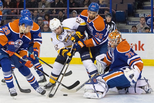 Nashville Predators' Mike Fisher is stopped by Edmonton Oilers goalie Cam Talbot  during first period NHL action in Edmonton, Alta., on Saturday January 23, 2016. After 17 seasons Fisher announced his retirement.