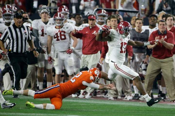 Alabama's Kenyan Drake gets past Clemson kicker Greg Huegel as he runs back a kick off for a touchdown during the second half of the NCAA college football playoff championship game Monday, Jan. 11, 2016, in Glendale, Ariz. 