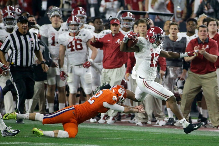 Alabama's Kenyan Drake gets past Clemson kicker Greg Huegel as he runs back a kick off for a touchdown during the second half of the NCAA college football playoff championship game Monday, Jan. 11, 2016, in Glendale, Ariz. 