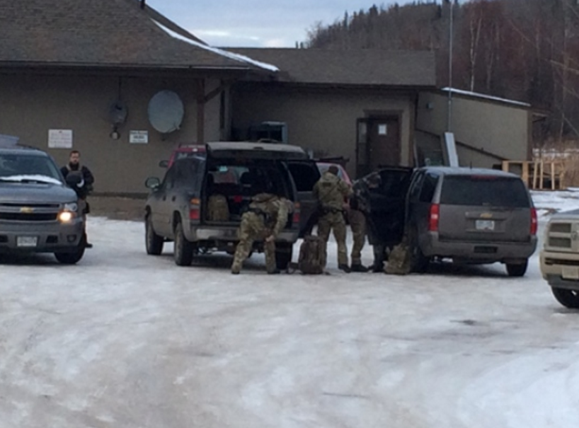 Tactical squads prepare as a home is surrounded north of Fort St. John on January 31, 2016. 