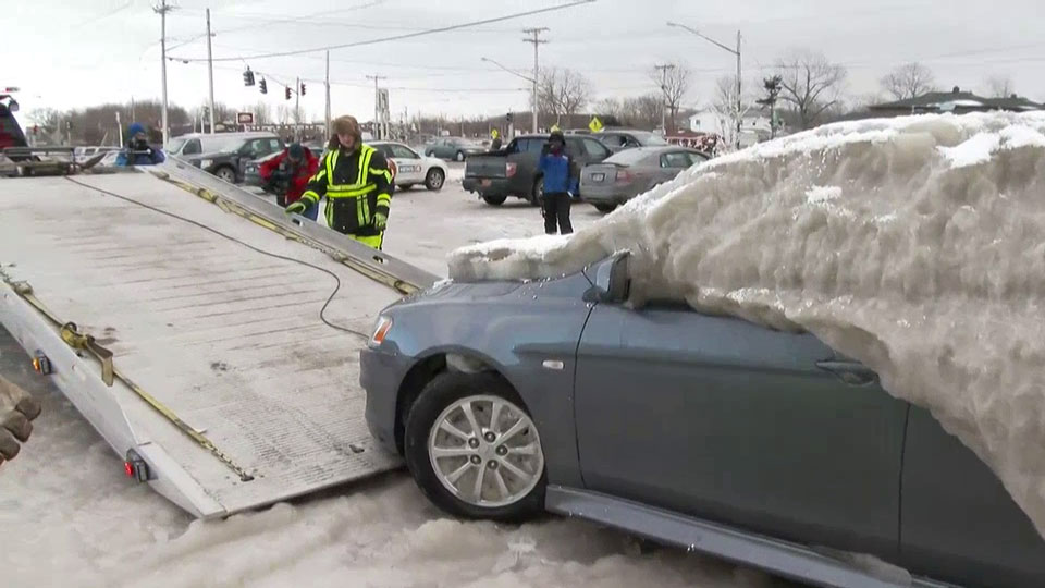 WATCH: Car cocooned in inches of ice, frozen to New York parking spot finally freed - image
