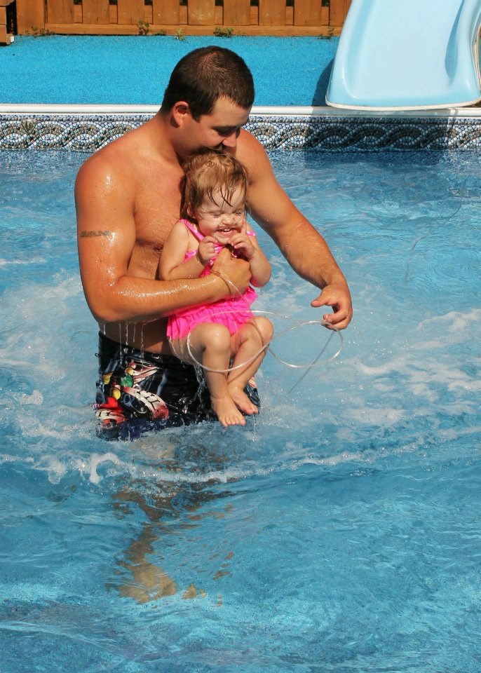 Carmen is pictured here swimming with her father, Andrew.