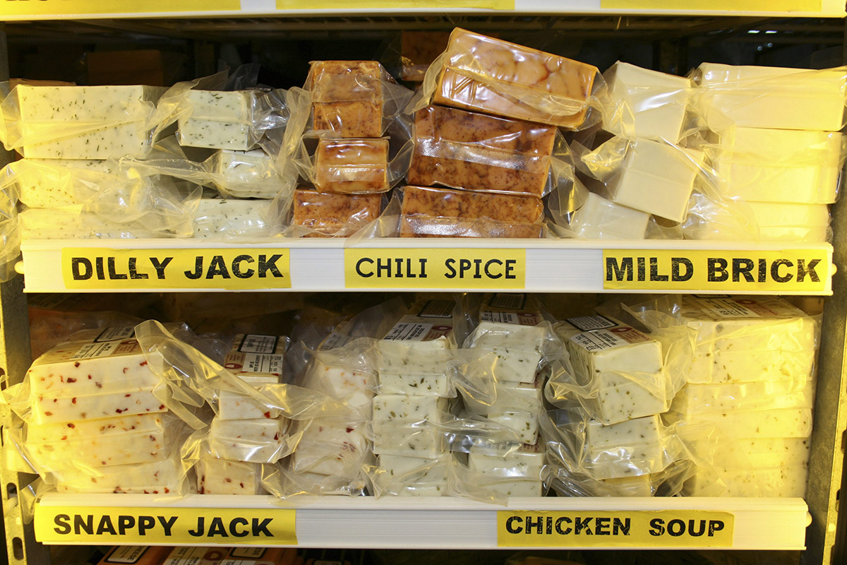 This Feb. 24, 2009 file photo shows flavored cheeses on the shelf at Beechwood Cheese Company in Beechwood, Wis.