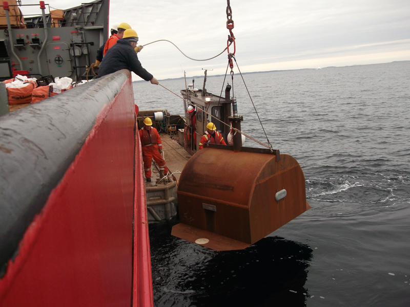 A cofferdam is placed in the water near the site of the Manolis L