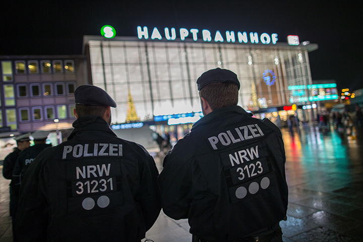 Police officers survey the area in front of the main train station and the Cathedral in Cologne, western Germany, on January 6, 2016.  