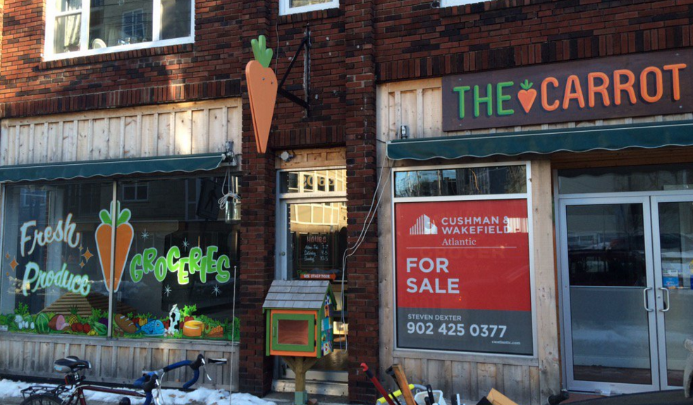 A "For Sale" sign is seen here in the window of The Community Carrot grocery store on Gottingen Street on Jan. 6, 2016. 