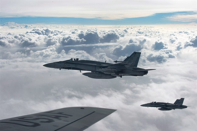 Royal Canadian Air Force CF-18 Hornets depart after refueling with a KC-135 Stratotanker assigned to the 340th Expeditionary Air Refueling Squadron, over Iraq.