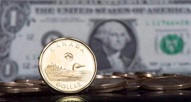 The Canadian dollar is displayed next to the US dollar, January 30, 2015 in Montreal. 