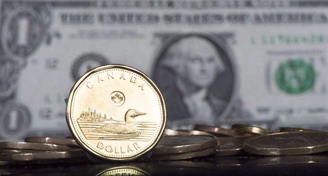 The Canadian dollar is displayed next to the US dollar, January 30, 2015 in Montreal. 
