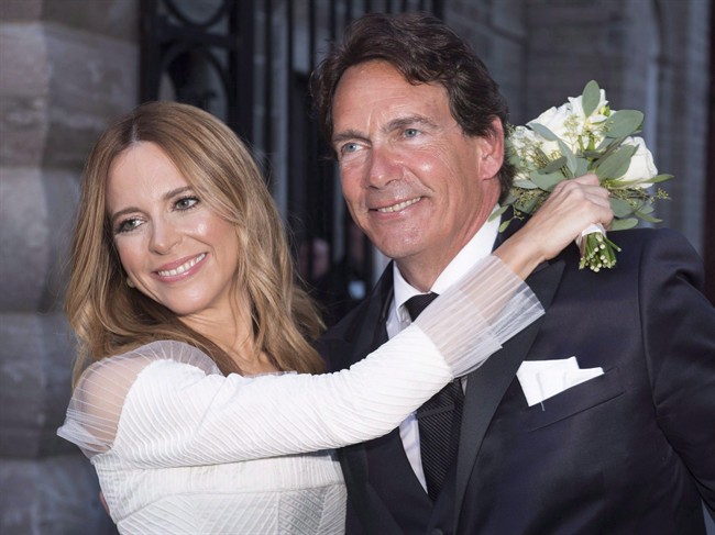 Parti Québécois leader Pierre Karl Péladeau and TV host Julie Snyder hug after getting married in Quebec City on August 15, 2015.