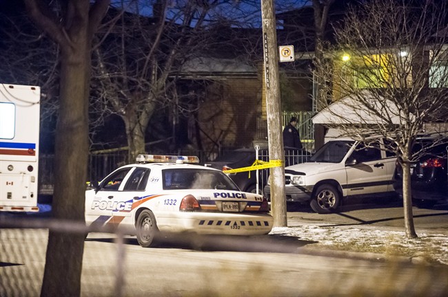 Police investigate a death in Toronto Friday, Jan. 29, 2016. Police have one man in custody in connection with the death of an 87-year old man in a central Toronto neighbourhood Friday afternoon.
