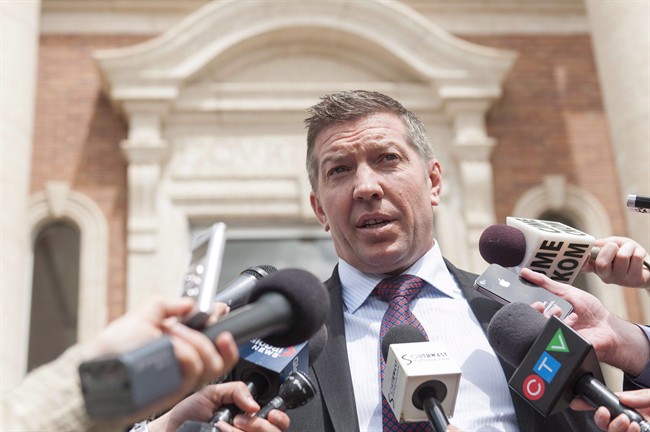 Sheldon Kennedy speaks to media outside the Court of Queen's Bench after the trial of Graham James, in Swift Current, Sask., on June 19, 2015. The former NHL hockey player is returning to the Saskatchewan city where he was sexually abused by his junior hockey coach to help protect other kids. THE CANADIAN PRESS/Michael Bell.