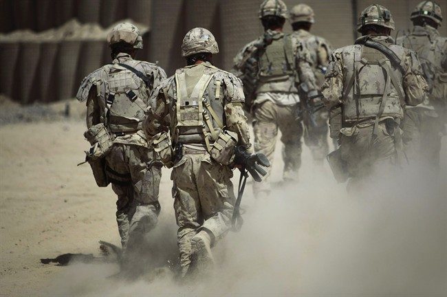 FILE: Canadian soldiers patrol southwest of Kandahar, Afghanistan, Monday, June 7, 2010. 
