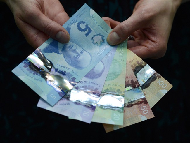 Polymer bank notes are shown during a news conference at the Bank of Canada in Ottawa on April 30, 2013. 