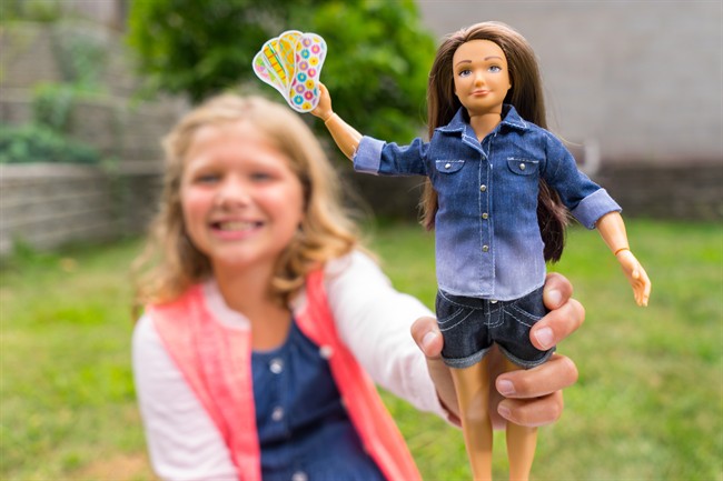 A girl is seen holding a Lammily doll with pads from the Period Party accessory pack in this undated handout photo. Lammily creator Nickolay Lamm said he hopes the accessory pack will help in normalizing discussion about menstruation with children. 