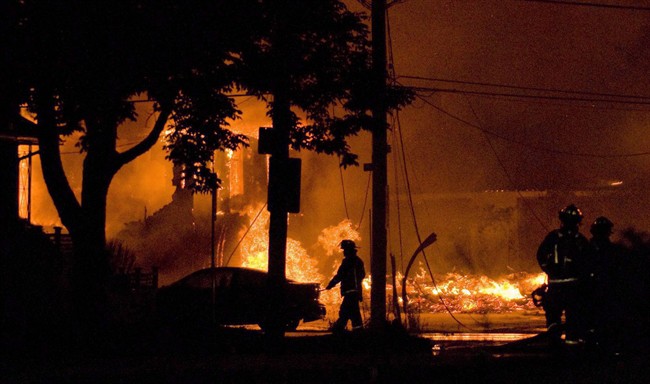 Firefighters work at the scene of a propane explosion at Sunrise Propane in Toronto early Sunday Aug. 10, 2008.