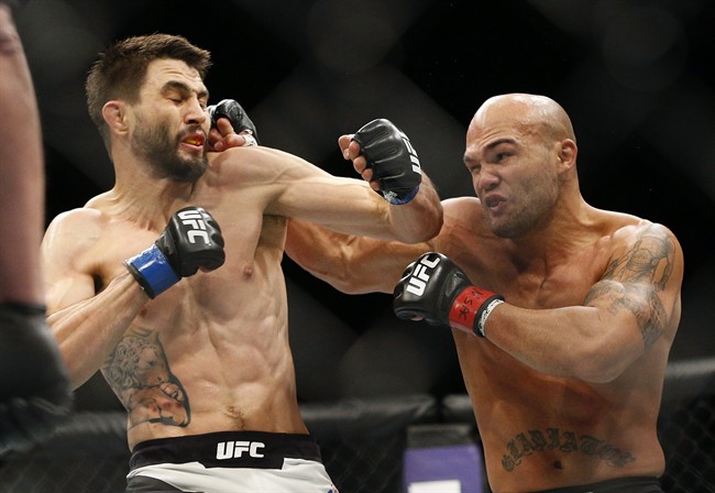 Robbie Lawler, right, hits Carlos Condit during a welterweight championship mixed martial arts bout at UFC 195, Saturday, Jan. 2, 2016, in Las Vegas. Lawler made a basic purse of US$500,000 for his hard-earned split-decision win over challenger Condit on Saturday at UFC 195.THE CANADIAN PRESS/AP/John Locher.