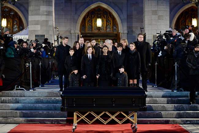 Celine Dion, with sons Eddy and Nelson, and Rene-Charles Angelil, stand before her late husband Rene Angelil's casket at Montreal's Notre-Dame Basilica on Friday, January 22, 2016.