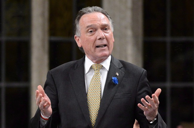Peter Kent responds to a question during question period in the House of Commons on Parliament Hill in Ottawa on June 3, 2013. Kent says the Liberal government shouldn't lift sanctions or re-open its embassy in Iran because of continuing threats to foreign diplomats.