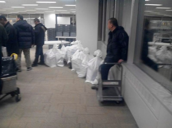 This year, line-ups at the immigration processing centre in Mississauga, Ont., began hours before the program opened to new applications on Jan. 4. Some couriers showed up with bags of what appeared to be hundreds of applications, according to photographs obtained by The Canadian Press. THE CANADIAN PRESS.