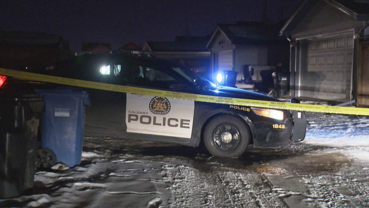 Police tape off a home along Cramond Close S.E. after the discovery of a body on Sunday, Jan. 24, 2016.