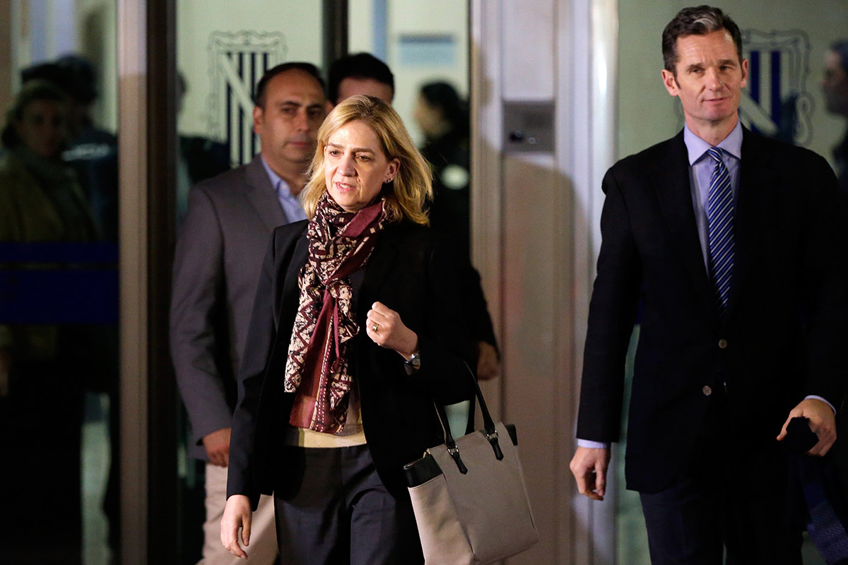 Spain's Princess Cristina and her husband Inaki Urdangarin, right, leave a makeshift courtroom on the first day of a corruption trial, in Palma de Mallorca, Spain, Monday, Jan. 11, 2016.