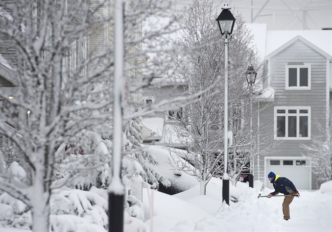 A man clears snow during a snow storm in Halifax, N.S., on Wednesday, January 13, 2016.