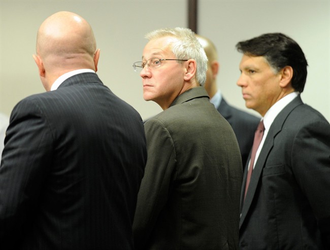 In this Thursday, April 19, 2012, file photo, Oscar Ray Bolin Jr., center, watches as the jurors walk into the courtroom in Tampa. 