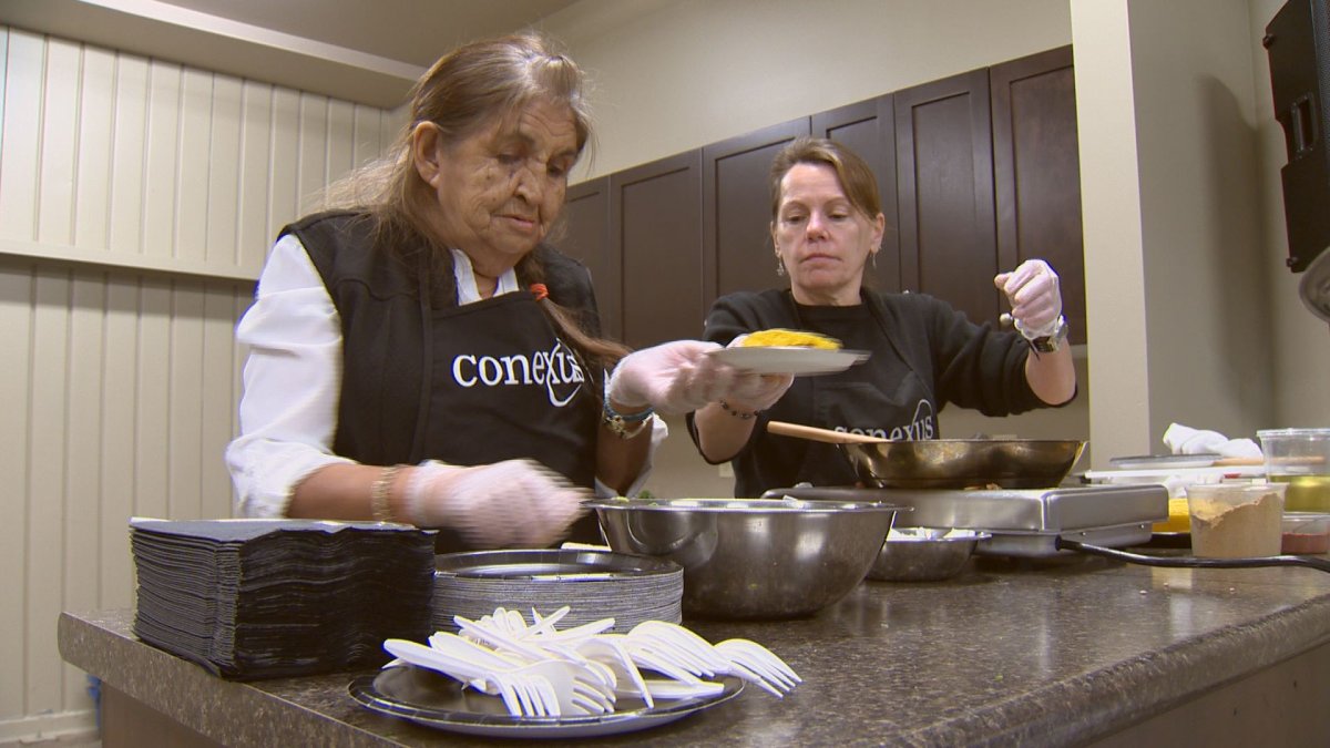 Two women prepare food the Friday's announcement by the Regina Food bank and Conexus Credit Union .