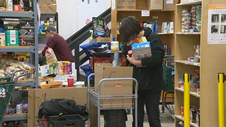 FILE: Workers at Fort McMurray's Wood Buffalo Food Bank stock food hampers.