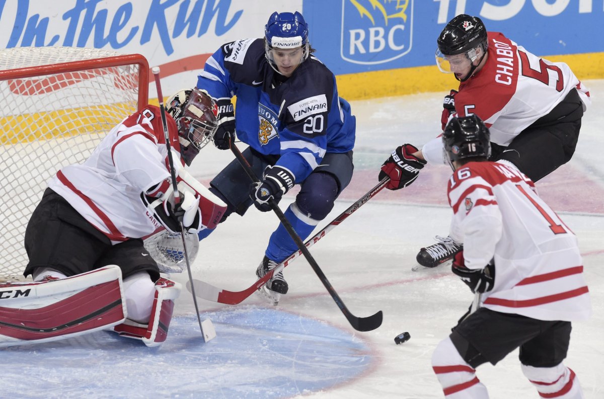 Finland's Sebastian Aho (2nd L) vies with goalkeeper Mackenzie Blackwood, Mitch Marner (front R) and Thomas Chabot of Canada during the 2016 IIHF World Junior Ice Hockey Championship quarterfinal match between Finland and Canada in Helsinki, Finland, on January 2, 2016. 