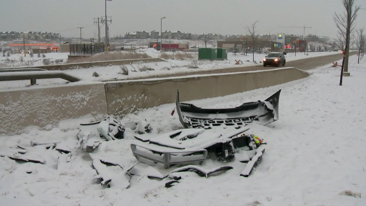 Calgary fire fighters jump into action after crash leaves car dangling from bridge - image