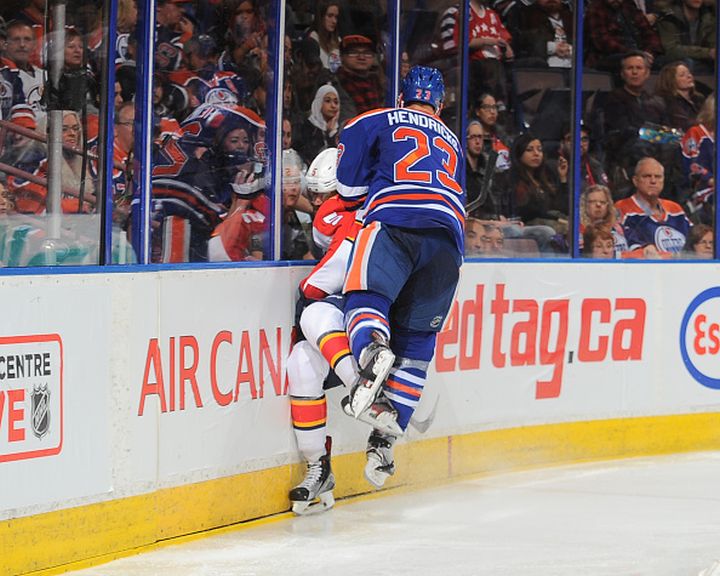 Matt Hendricks #23 of the Edmonton Oilers lands a big hit on Aaron Ekblad #5 of the Florida Panthers on January 10, 2016 at Rexall Place in Edmonton, Alberta, Canada.