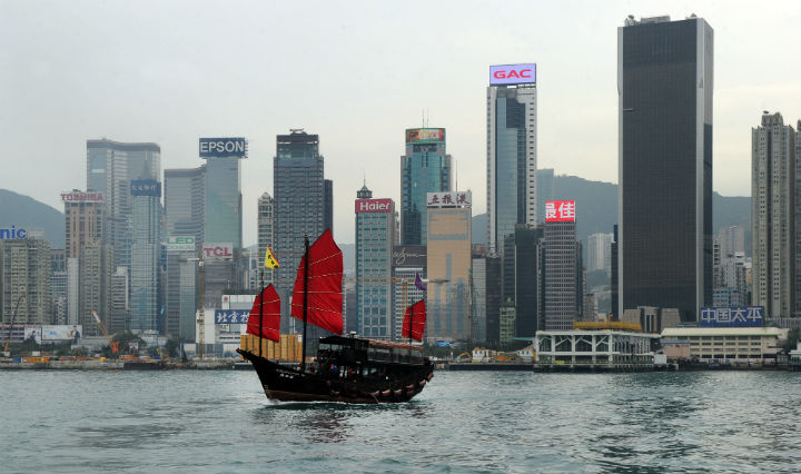 FILE - The Aqua Luna, one of Hong Kong's last remaining traditional Chinese junks, sailing past Hong Kong's skyline.