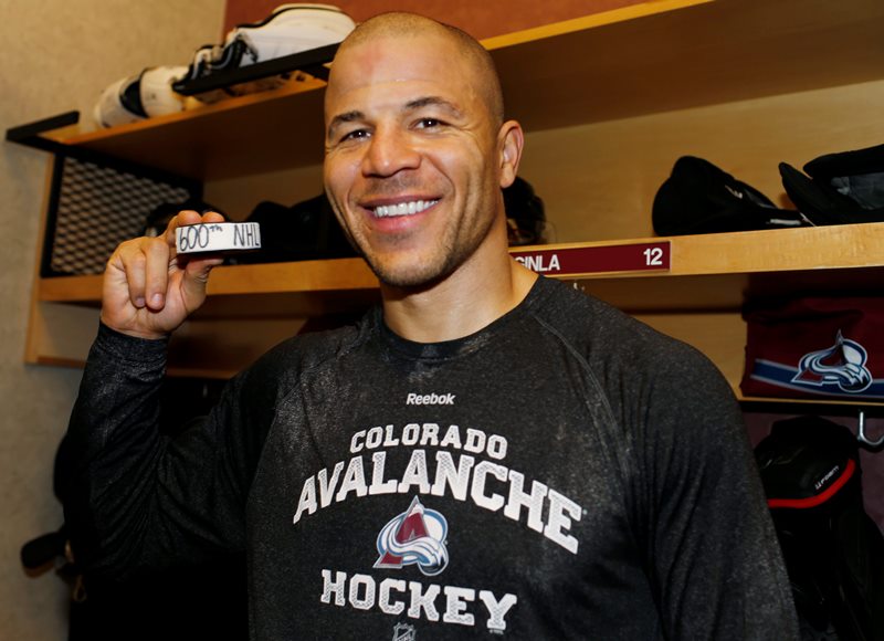 Colorado Avalanche right wing Jarome Iginla holds up the puck in the locker room after he scored his 600th career goal in an NHL hockey game against the Los Angeles Kings, Monday, Jan. 4, 2016, in Denver. Colorado won 4-1.