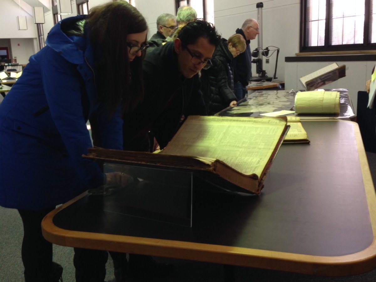 Visitors studying original artifacts of Manitoba's Suffrage Movement.