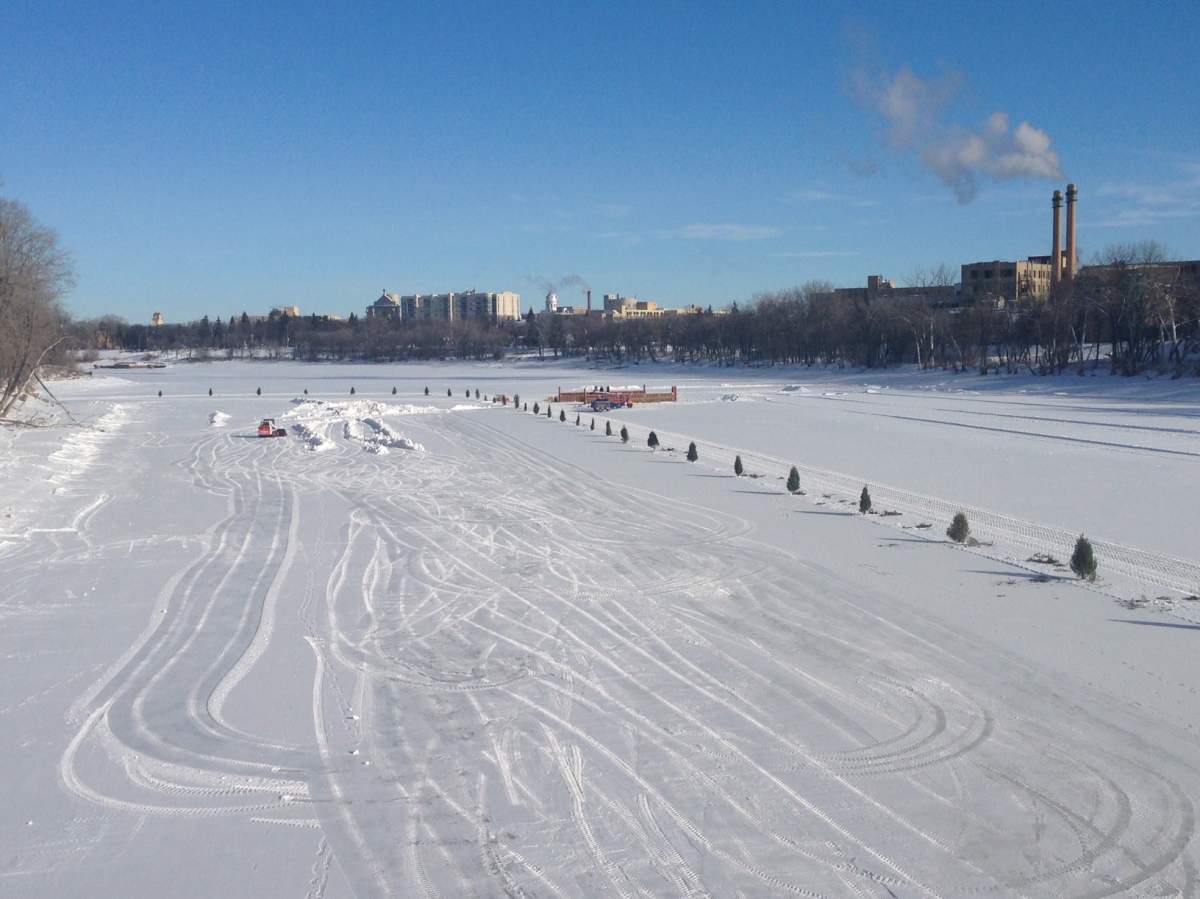 Crews working on the river trail near The Forks. 
