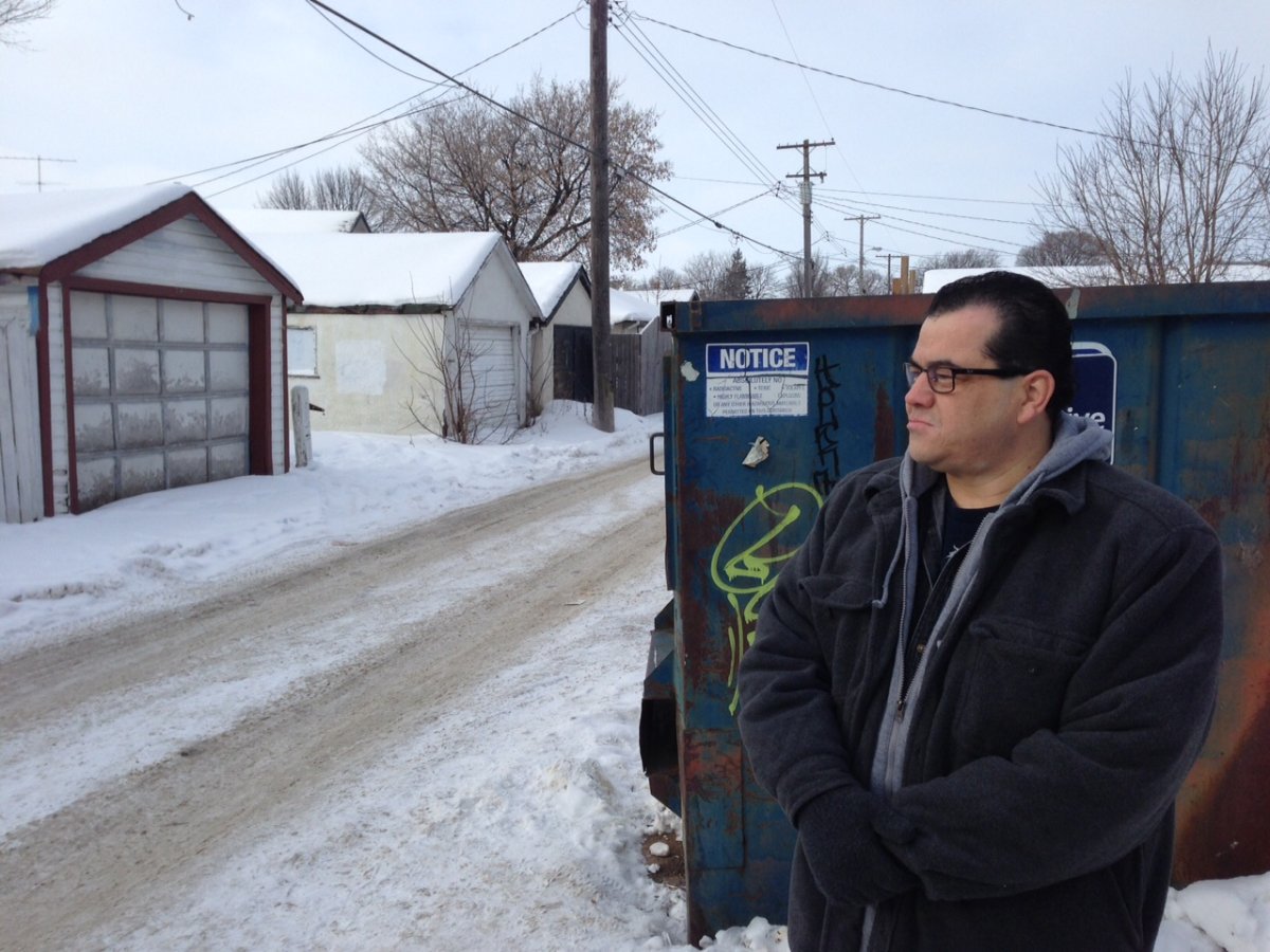 John Morrissette looks on as he stands beside the dumpster his 13-year-old son was dumped into after being assaulted.