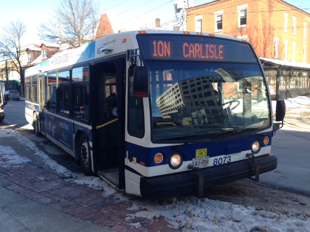A transit bus sits here at a bus stop in Fredericton. 