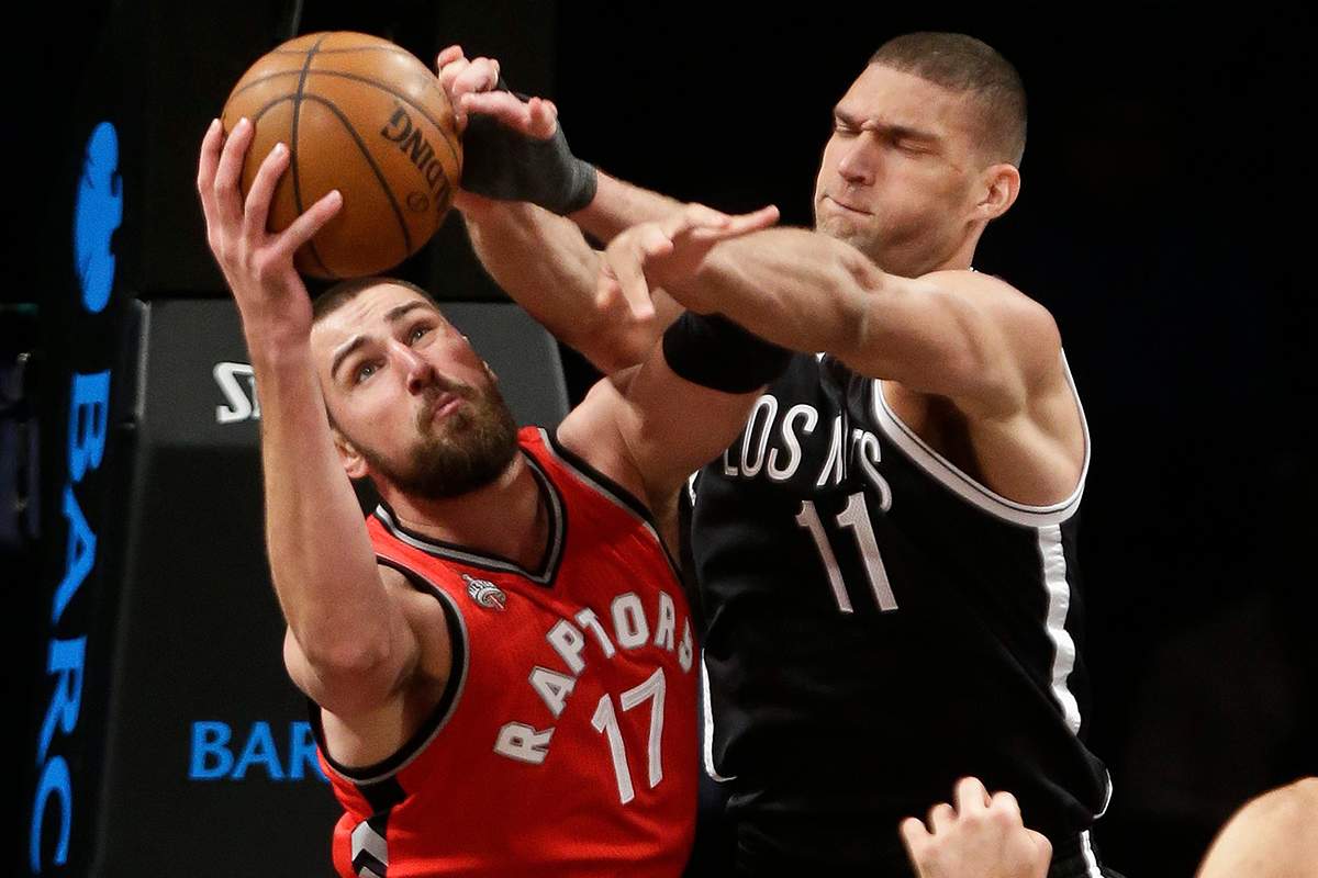 Toronto Raptors' Jonas Valanciunas (17) and Brooklyn Nets' Brook Lopez (11) fight for a rebound during the second half of an NBA basketball game Wednesday, Jan. 6, 2016, in New York.