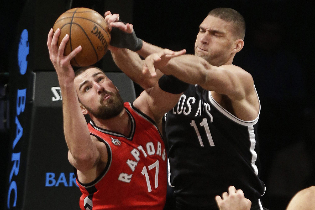 Toronto Raptors' Jonas Valanciunas (17) and Brooklyn Nets' Brook Lopez (11) fight for a rebound during the second half of an NBA basketball game Wednesday, Jan. 6, 2016, in New York.