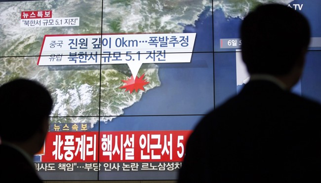People walk by a screen showing the news reporting about an earthquake near North Korea's nuclear facility, in Seoul, South Korea, Wednesday, Jan. 6, 2016. South Korean officials detected an "artificial earthquake" near North Korea's main nuclear test site Wednesday, a strong indication that nuclear-armed Pyongyang had conducted its fourth atomic test. North Korea said it planned an "important announcement" later Wednesday. The letter read "5.1 Earthquake near North Korea's nuclear facility." (AP Photo/Lee Jin-man).
