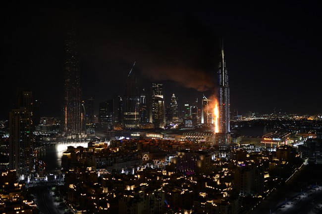 Smoke and flames pouring from a residential building, which also contains the Address Downtown Hotel, in Dubai, United Arab Emirates, Thursday evening, Dec. 31, 2015.