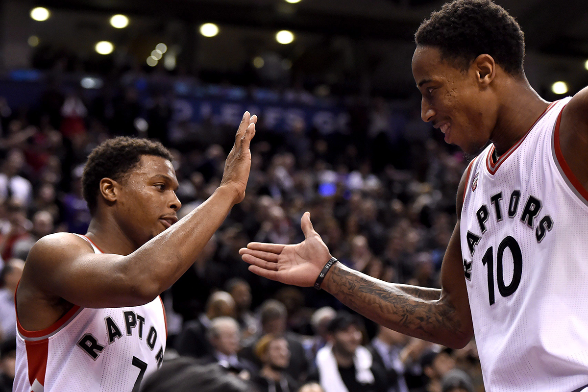 Toronto Raptors' DeMar DeRozan (10) and Kyle Lowry celebrate the dying seconds of their winning game against the Brooklyn Nets.