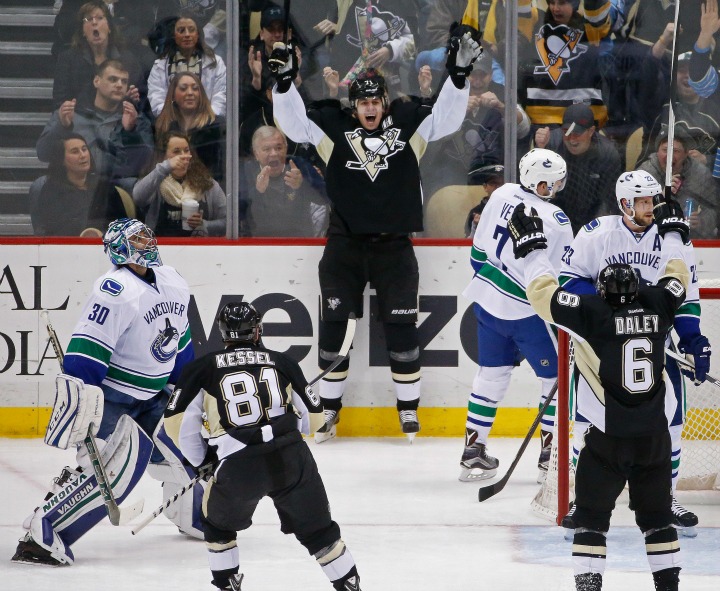 Pittsburgh Penguins' Evgeni Malkin (71) celebrates his second goal of the game against Vancouver Canucks goalie Ryan Miller (30) during the third period of an NHL hockey game in Pittsburgh, Saturday, Jan. 23, 2016. Malkin had a hat-trick in the Penguins 5-4 win. 