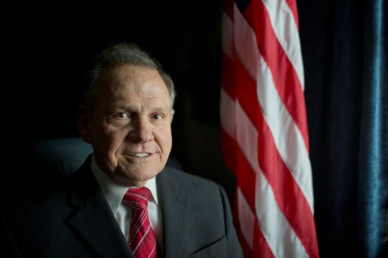  In this Feb. 17, 2015, file photo, Alabama Chief Justice Roy Moore poses in front the the American flag in Montgomery, Ala. Moore issued an administrative order Wednesday, Jan. 6, 2016, saying the Alabama Supreme Court never lifted a March 2015 directive to probate judges to refuse licenses to gay couples. He said the order to refuse the licenses remains in "full force" despite the U.S. Supreme Court ruling more than six months ago that effectively legalized same-sex marriage throughout the country. 