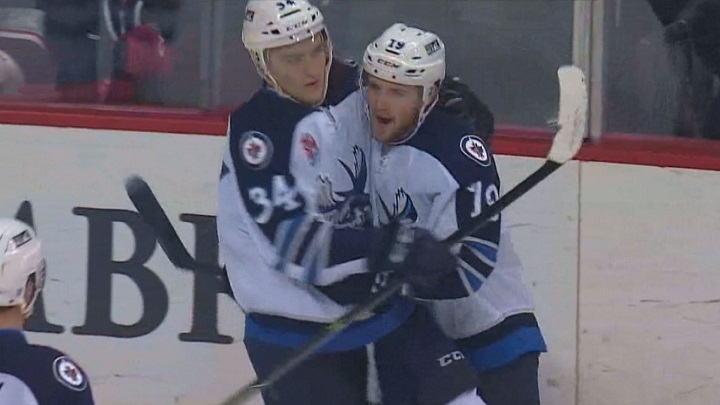 Chase De Leo (right) and JC Lipon celebrate a first period goal during a game between the Manitoba Moose and Grand Rapids Griffins on January 5, 2016.
