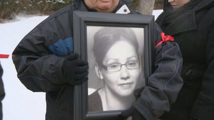 Laura Apooch holds a picture of Nadine Machiskinic at Sunday's vigil.